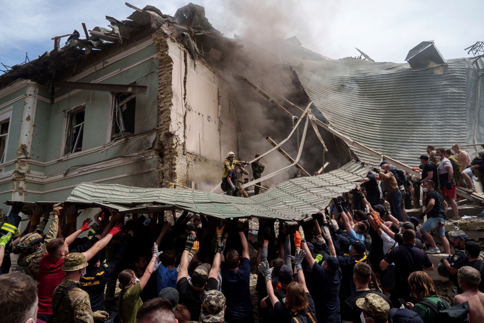 Workers remove debris from a destroyed hospital 